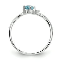 Prsten je od bijelog zlata s plavim topazom i dijamantom.